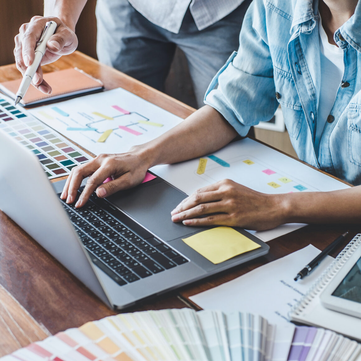 Team of Creative Web/Graphic Designer planning, drawing website ux app for mobile phone application and development template layout, process to developing prototype wireframe, User experience concept.