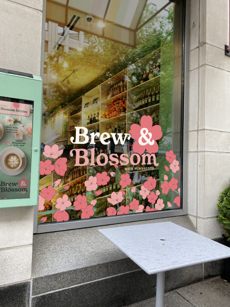 The exterior of Puro Gusto Cafe with the Brew and Blossom window decoration designs